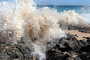 Waves splashing on basalt rocks at Ocean beach Bunbury Western Australia photo