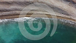 Waves splashing on the beach, aerial view