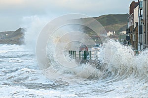 Waves splashing over coast road