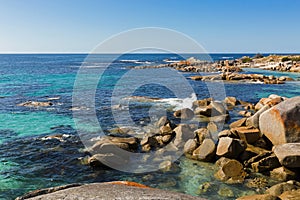 Waves splashing rocks at Bay of Fires in Tasmania, rocky coastline in Australia.