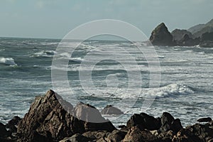 Waves splashing on the rocks of New Zealand coastline