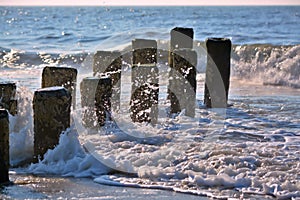 Waves Splashing up Against Wooden Jetty in Ocean