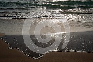 Waves spreading at the shore during sunset