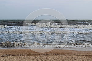 Waves during a storm at sea. in the distance you can see large ships and barges