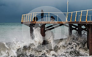 Waves of a stormy sea crushing on pier