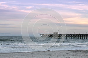 Rolling waves under sunset with Pier.