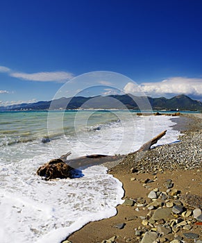 Waves and surf on the beach.  Pebble beach in the resort of Kabardinka, Krasnodar region, Black sea.