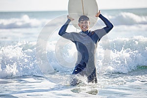 Waves, surfing and man surfer with surfboard at the beach, sea or ocean with a smile and is happy on a summer day