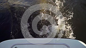 Waves, a trail of water behind the boat. Sailing on a yacht or ship on the sea.