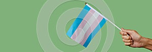 Waves a transgender pride flag, web banner
