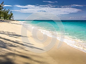 Waves of turquoise sea water washed ashore