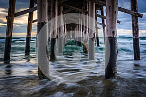 Waves under the pier, in Newport Beach