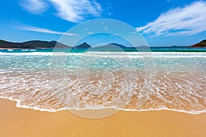 Waves wash onto the beautiful beach. photo