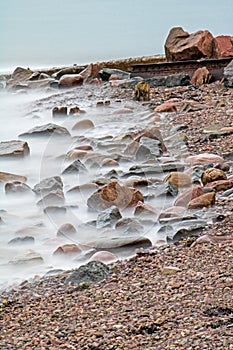Waves Wash The Rocks On The Shoreline Of The Bay Of Fundy photo