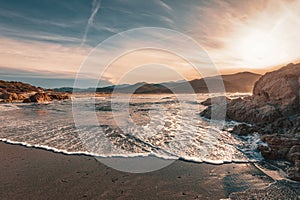 Waves washing onto Ostriconi beach in Balagne region of Corsica