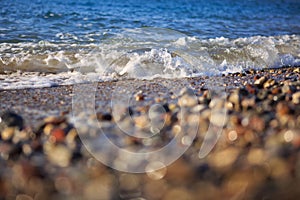 Waves washing over gravel beach, macro shot.