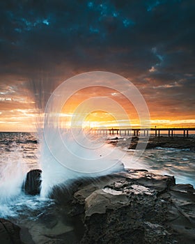 Waves Washing Over Rocks at Sunrise