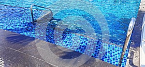 Waves on the water surface The water ripples in the pool and overlooking blurred bright blue