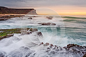 Waves and waterfalls coastal seascape