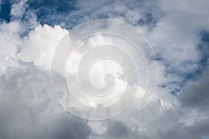 Waves of white fluffy clouds against the blue sky