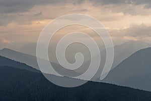 Wavey ridge lines of varying mountain ranges are contrasted by the one in front creating depth and texture in Olympic National