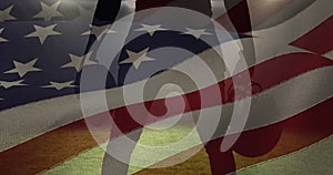 Waving american flag against male rugby player holding ball and helmet against sports stadium