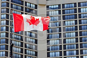 Waving canadian flag and building in the background