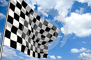 Waving checkered flag in front of a cloudy sky