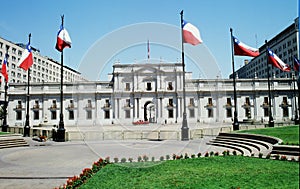 Waving Chilean national flag symbol on top of presidential La Moneda Palace,