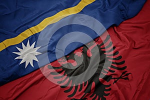 waving colorful flag of albania and national flag of Nauru