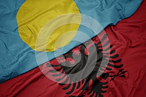 waving colorful flag of albania and national flag of Palau