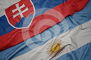 Waving colorful flag of argentina and national flag of slovakia