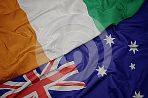 waving colorful flag of australia and national flag of cote divoire