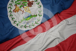 waving colorful flag of austria and national flag of belize