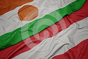 waving colorful flag of austria and national flag of niger