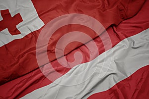 waving colorful flag of austria and national flag of Tonga