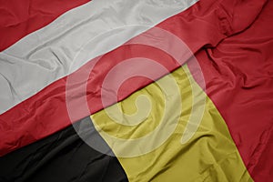 waving colorful flag of belgium and national flag of austria