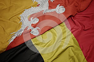 waving colorful flag of belgium and national flag of bhutan