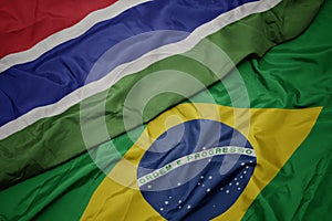 waving colorful flag of brazil and national flag of gambia photo