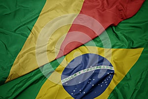 waving colorful flag of brazil and national flag of republic of the congo photo