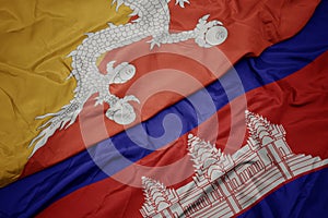 waving colorful flag of cambodia and national flag of bhutan