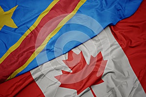 waving colorful flag of canada and national flag of democratic republic of the congo