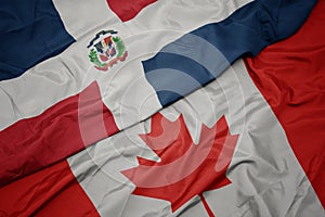 waving colorful flag of canada and national flag of dominican republic