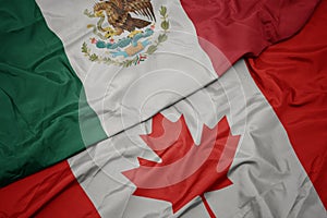 waving colorful flag of canada and national flag of mexico