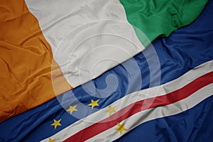 waving colorful flag of cape verde and national flag of cote divoire