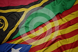 waving colorful flag of catalonia and national flag of Vanuatu