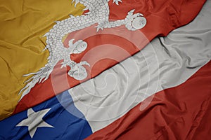 waving colorful flag of chile and national flag of bhutan
