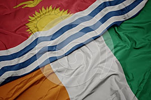 Waving colorful flag of cote divoire and national flag of Kiribati