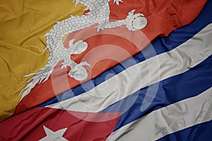 waving colorful flag of cuba and national flag of bhutan