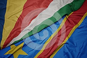 waving colorful flag of democratic republic of the congo and national flag of seychelles